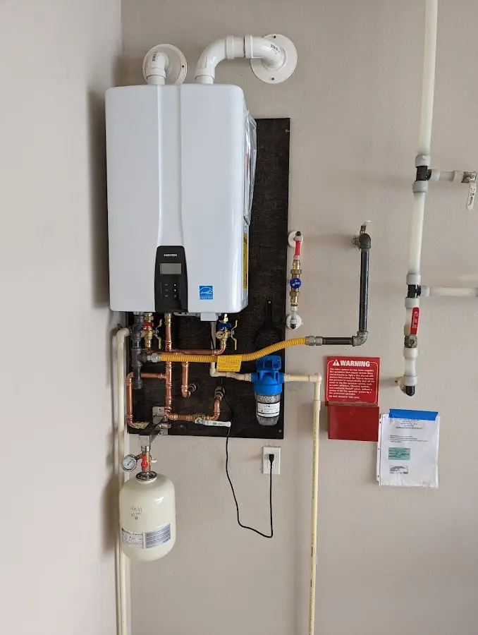 Professional plumber installing copper piping in a Nikiski home
